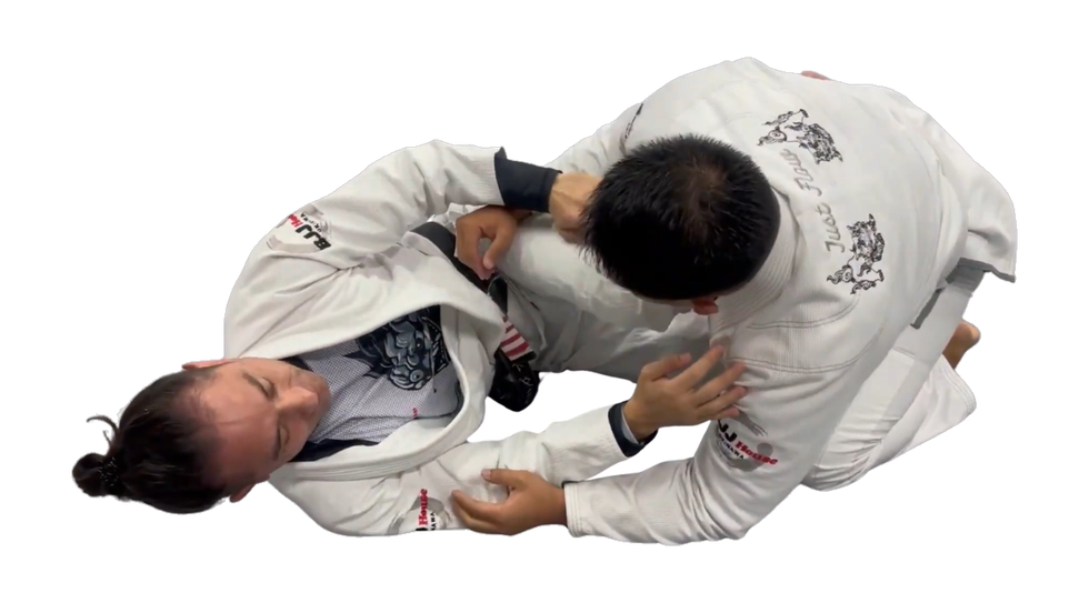 Helio Damiani Jr. attacking from bottom half guard during a Brazilian Jiu Jitsu class in Ginowan, Okinawa