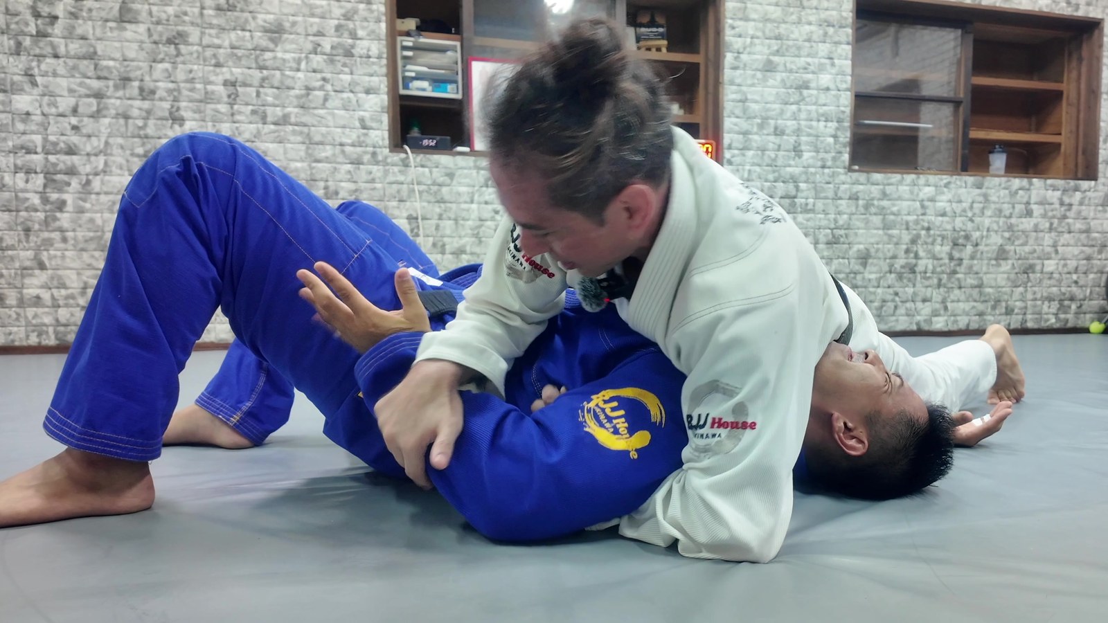 Helio Damiani Jr. applying a kimura on a training partner during a Brazilian Jiu Jitsu class at BJJ House Okinawa in Ginowan, Okinawa